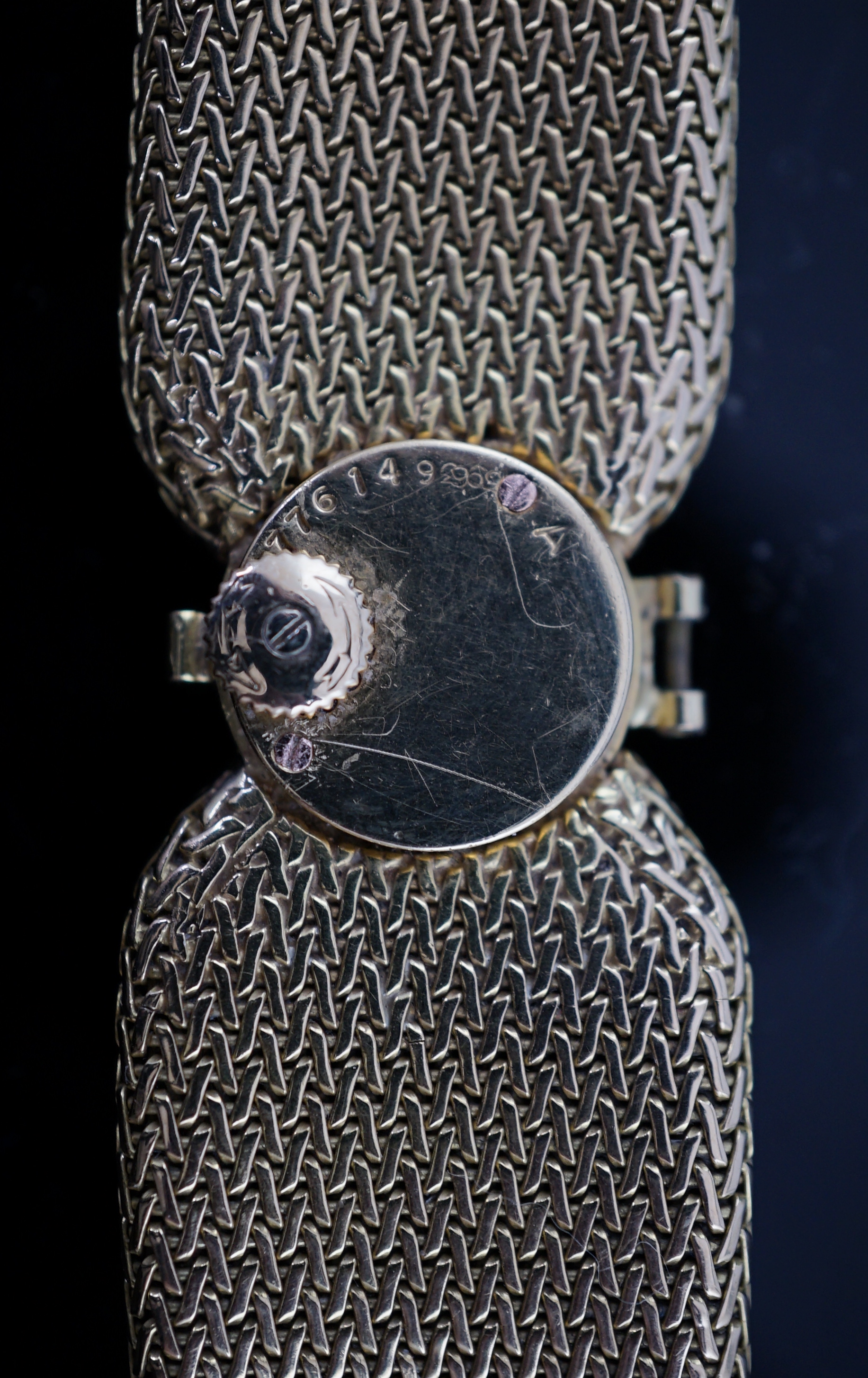 A lady's 18ct gold and eight stone diamond set manual wind cocktail, the dial inscribed Cartier, on integral tapered gold bracelet set with eight round cut stones